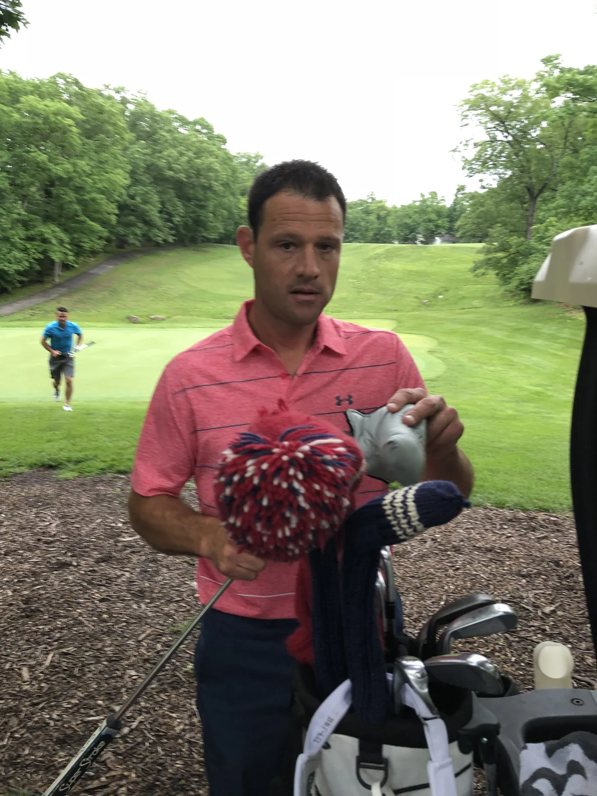 A golfer in a bright pink patterned shirt
