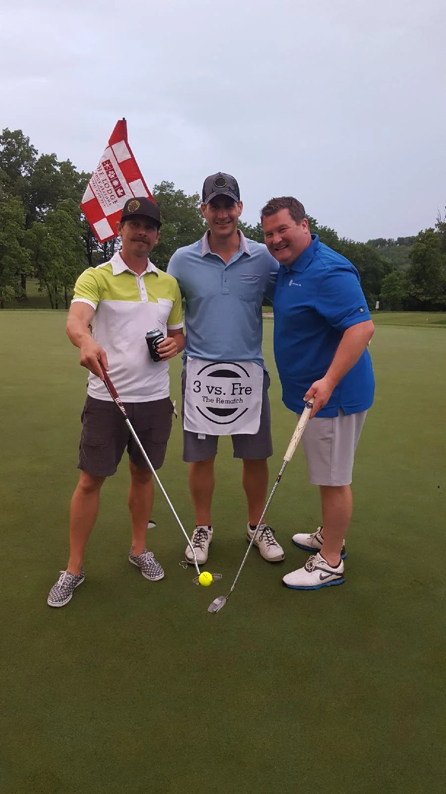 Three friends posing on the golf course