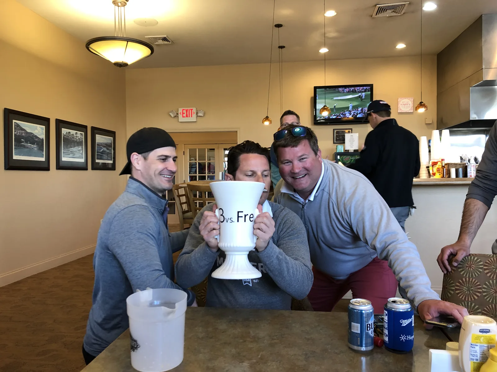 Friends gathered with the trophy in the clubhouse