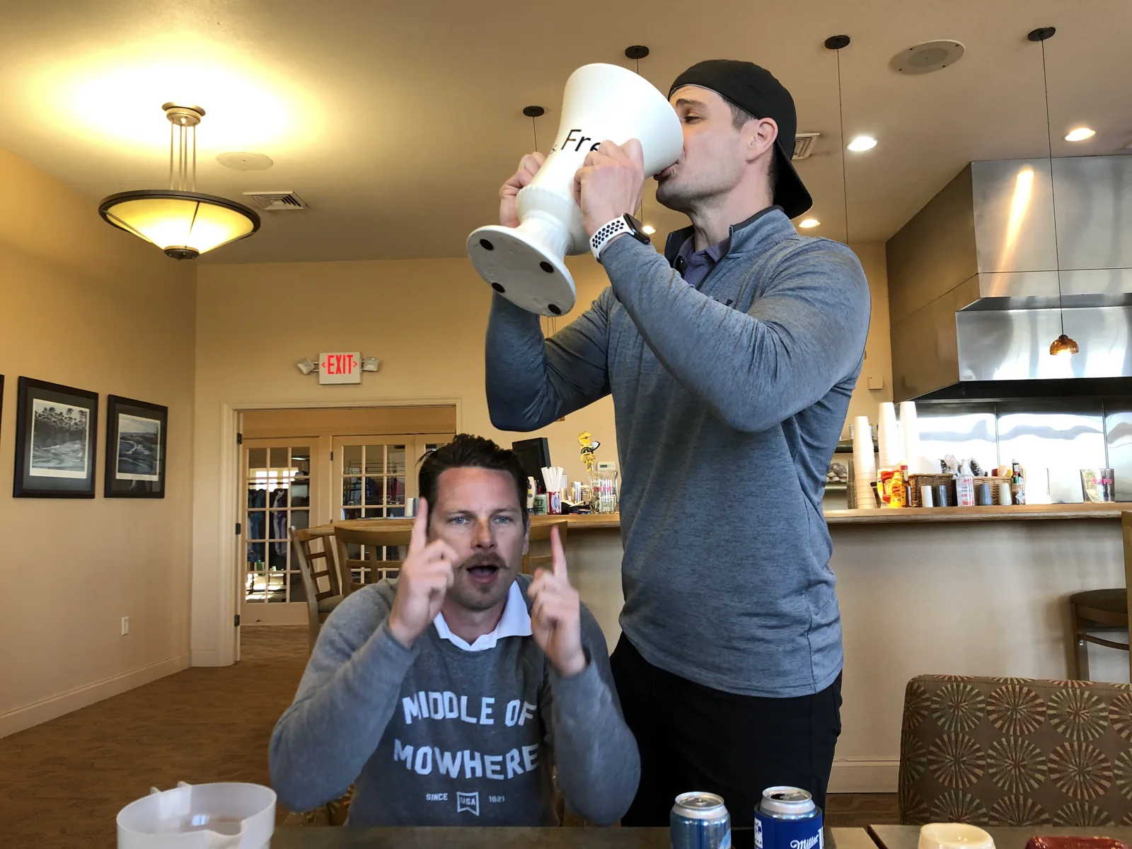 A friend drinking from the oversized trophy