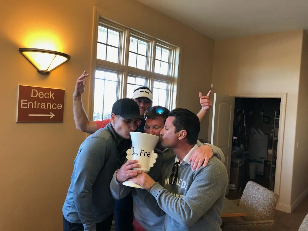 Friends celebrating together with the trophy