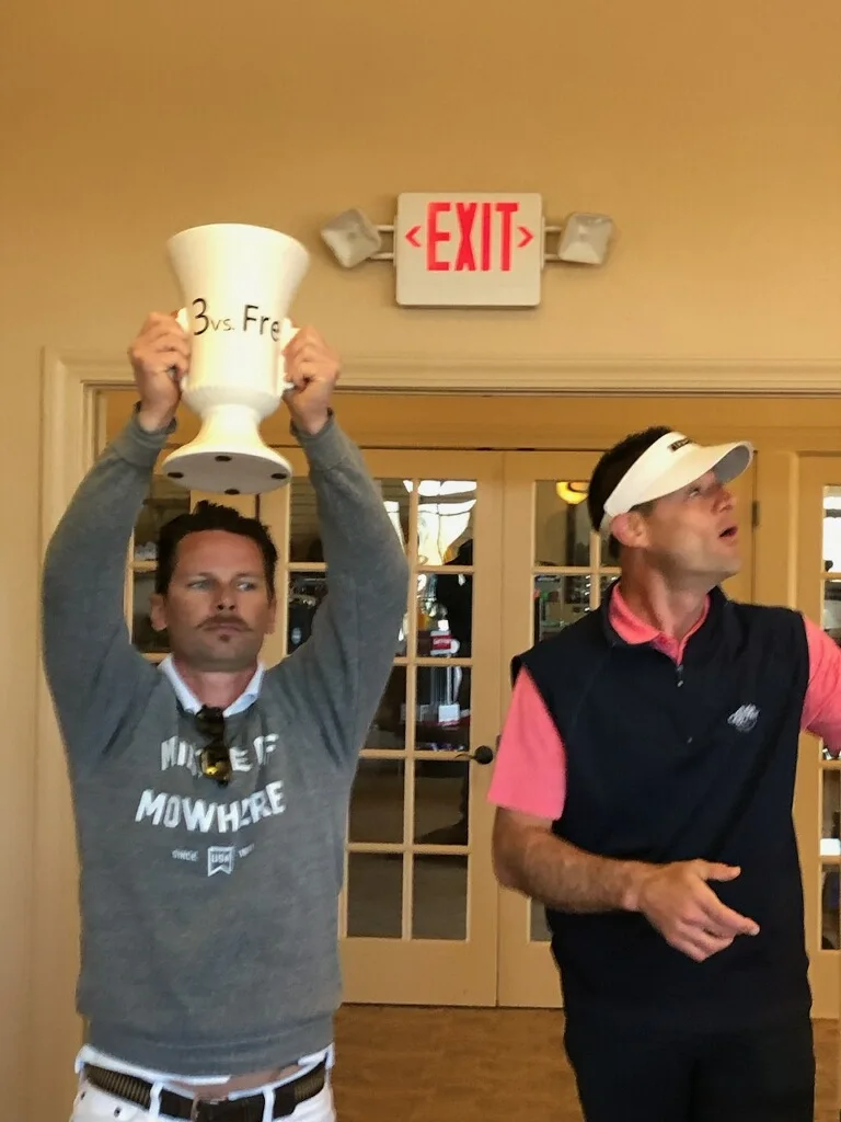 A friend raising the trophy overhead