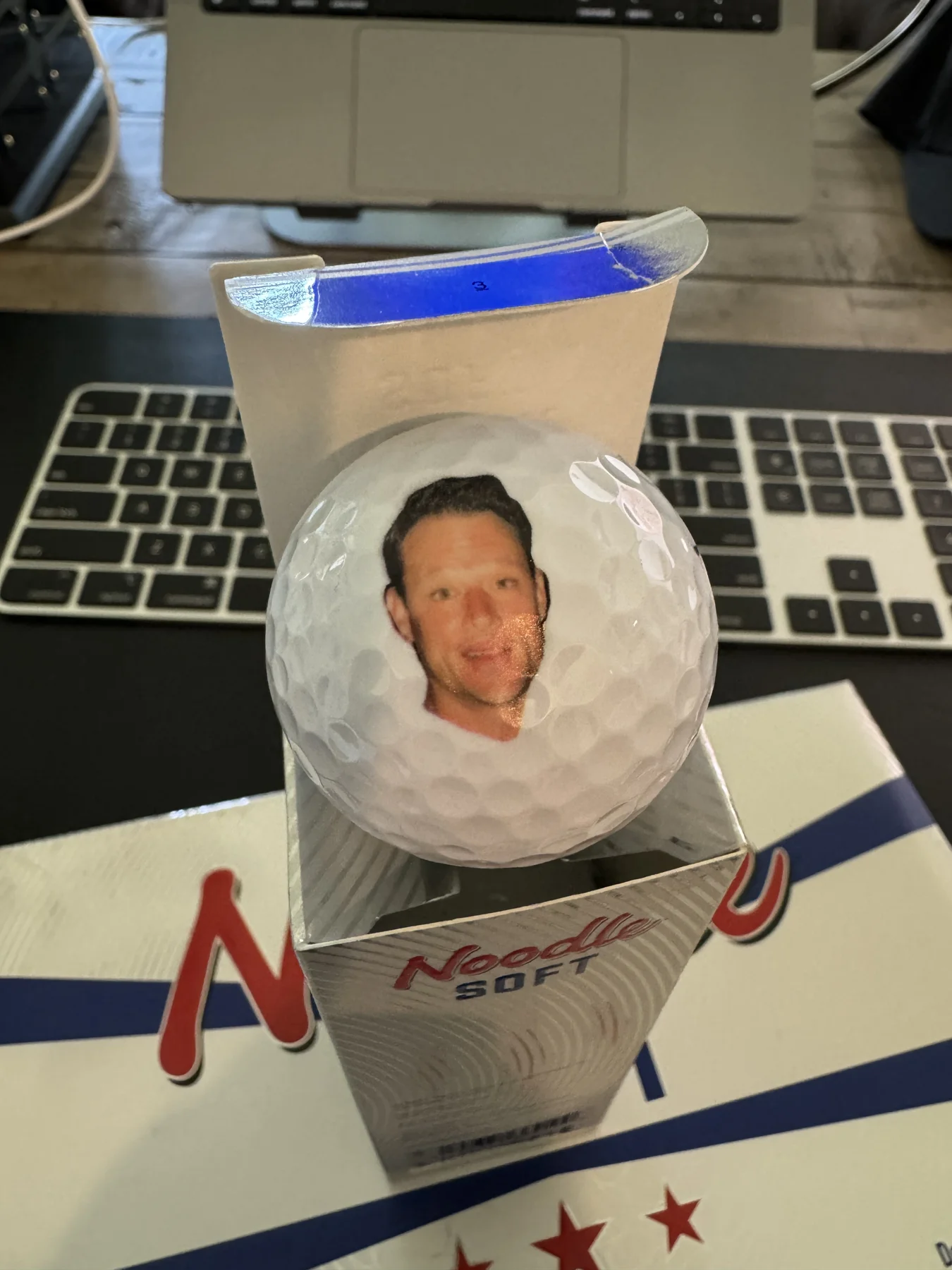 A custom drink koozie printed with a friend's face
